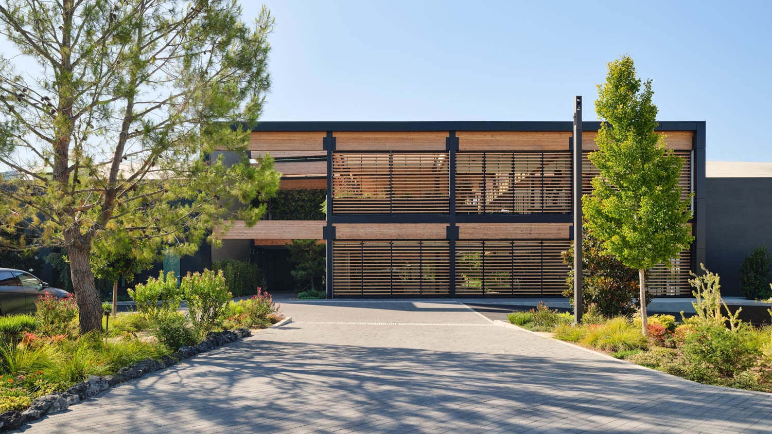 warehouse exterior with slatted windows and trees