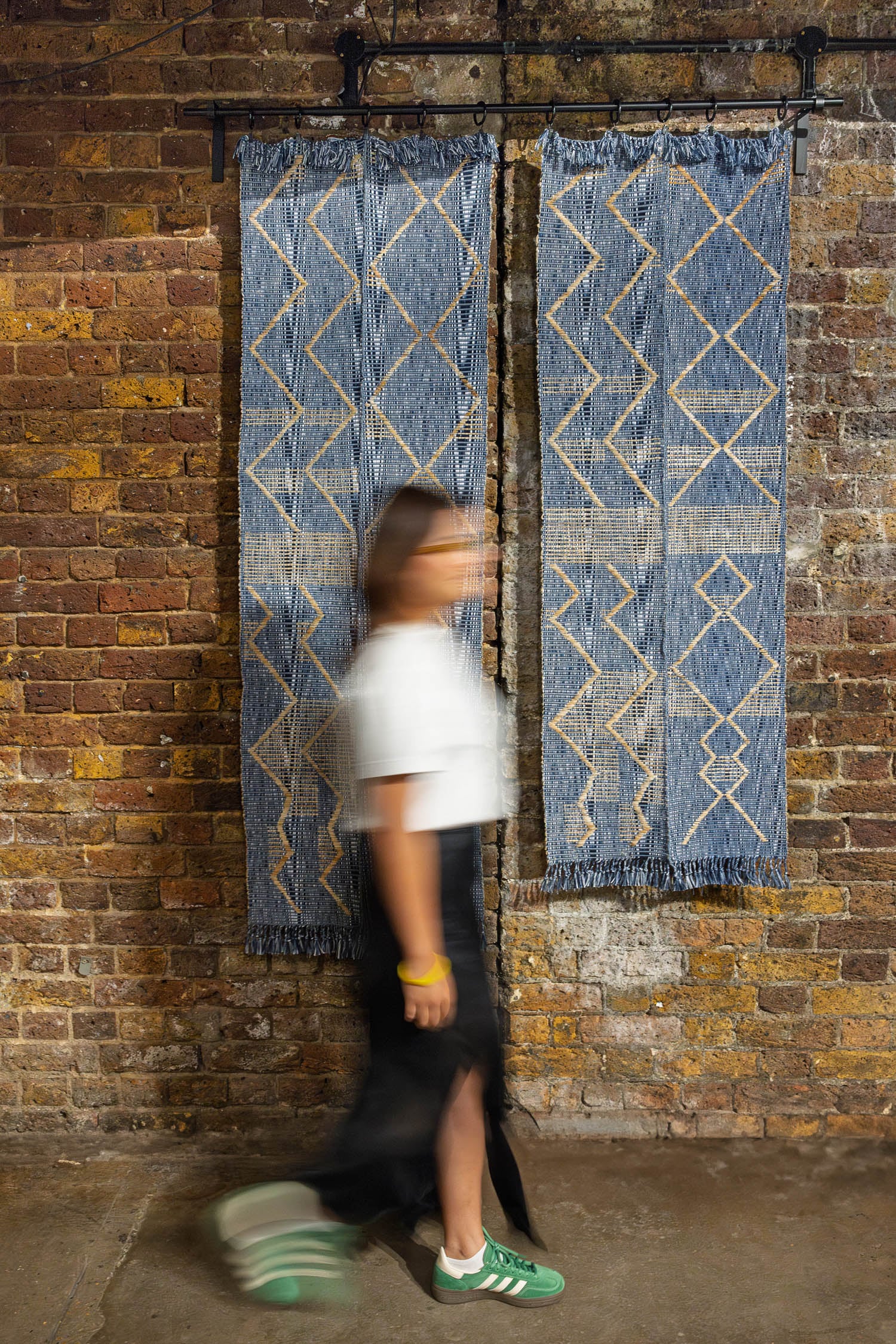 person walking next to blue fabric