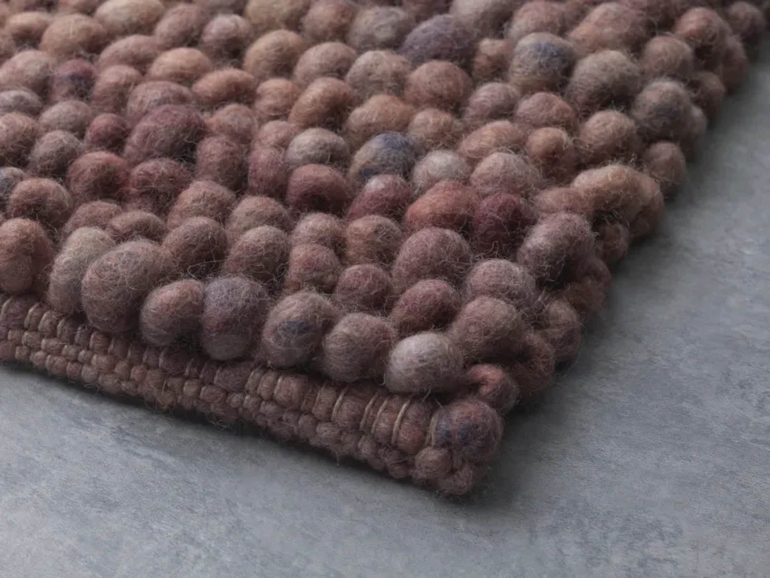 closeup of rug with wool balls