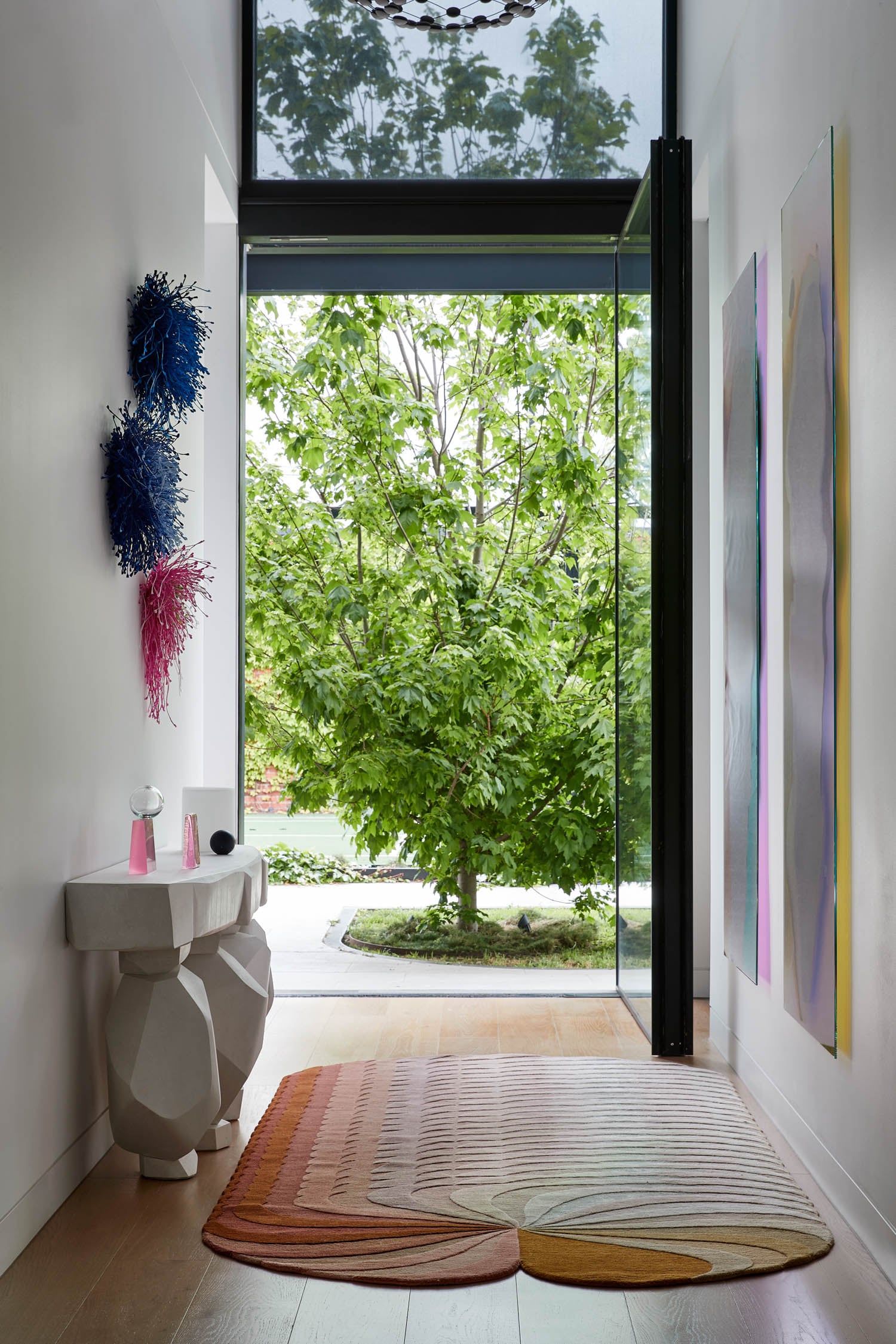 entryway with sculptural art hanging on both sides