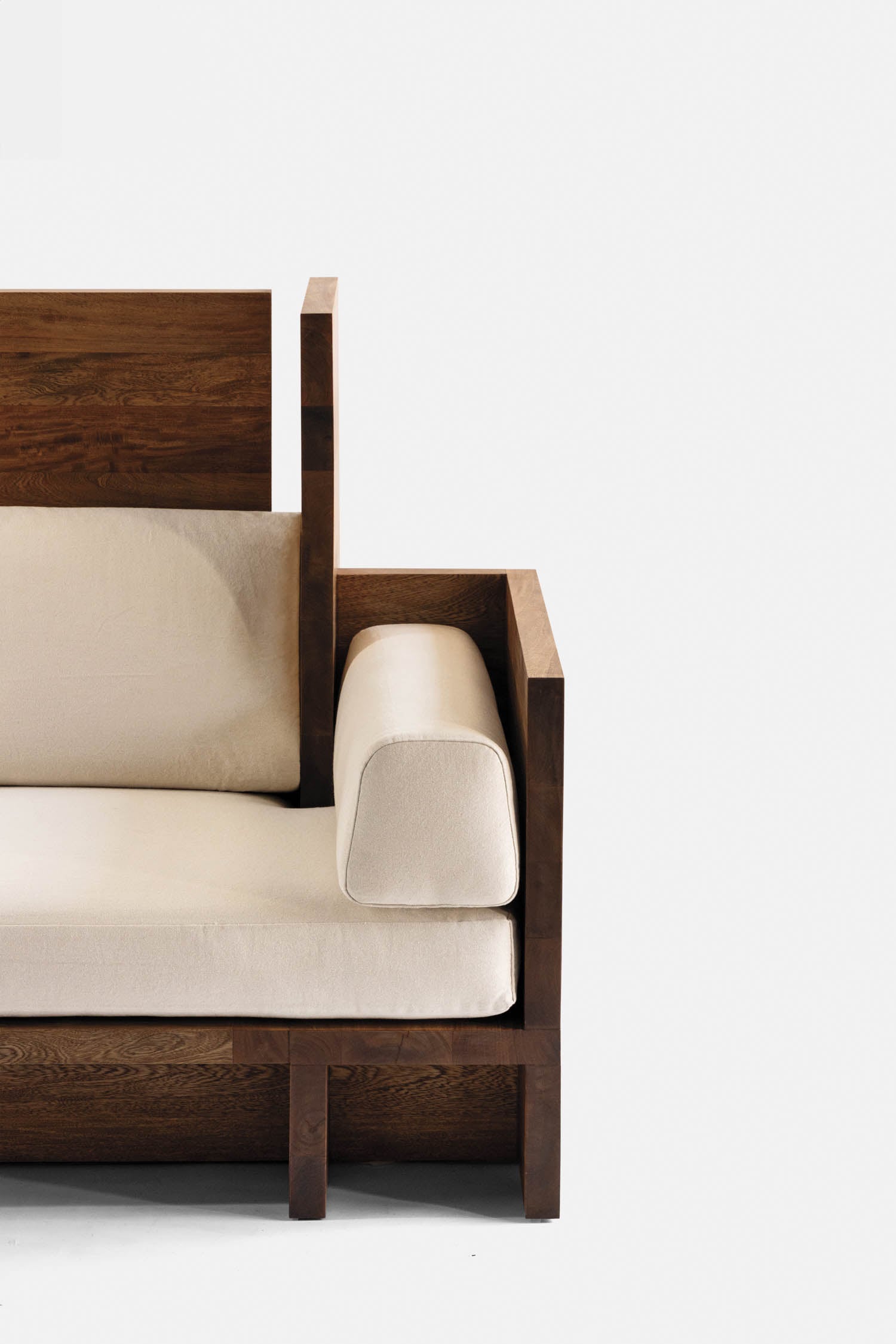 A wooden chair with a white cushion