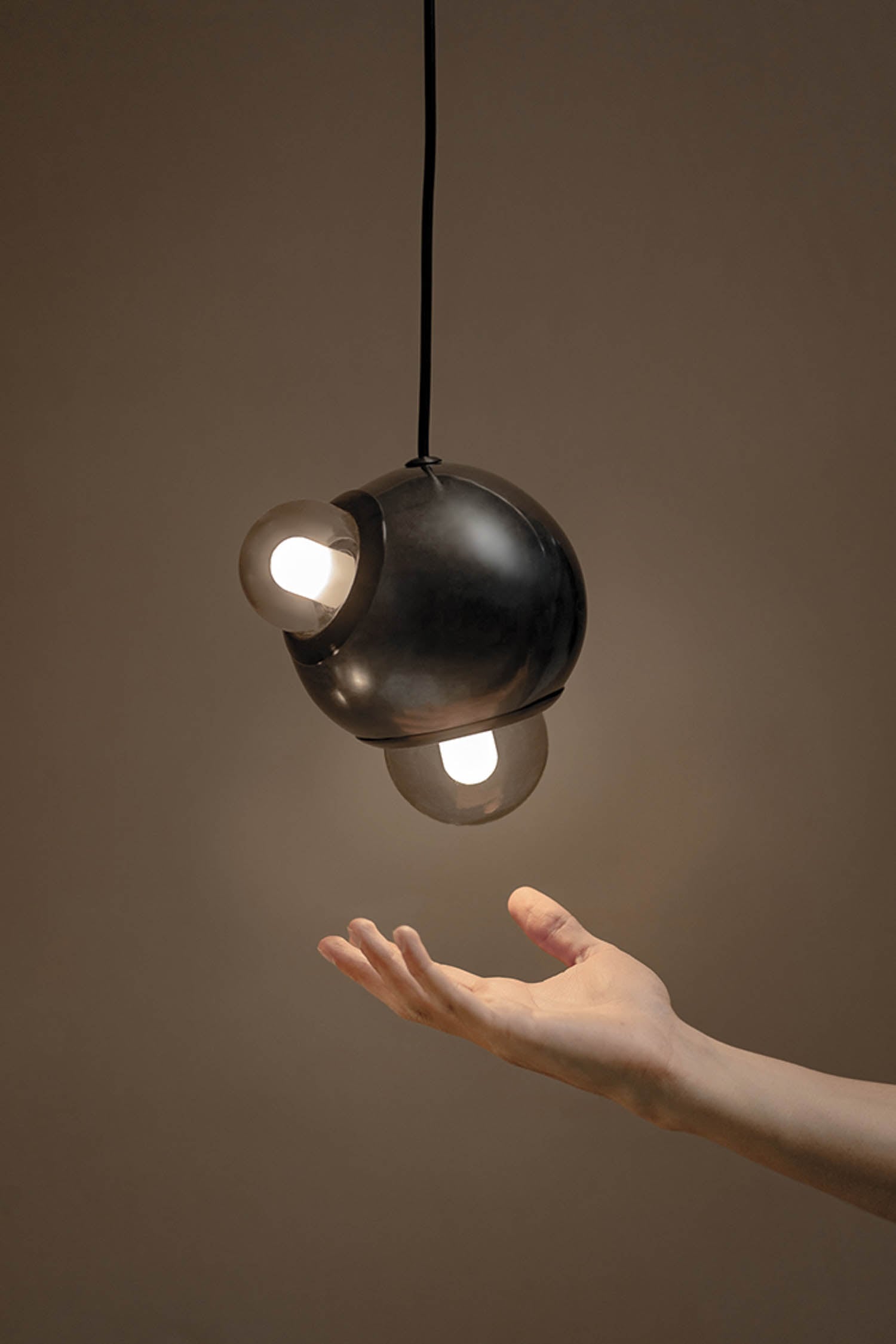 A hand holding a light bulb in the air