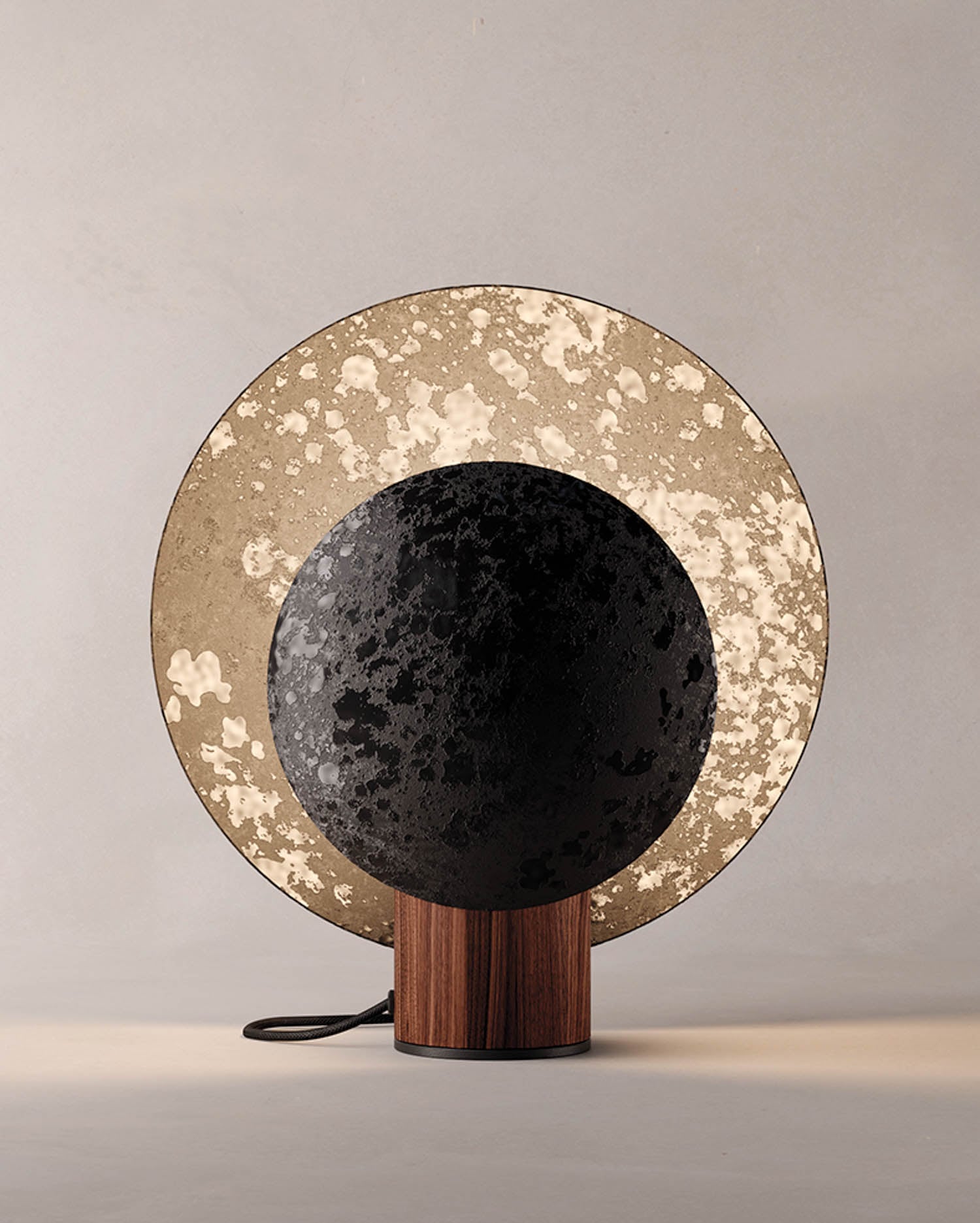 A black and gold plate on a wooden stand