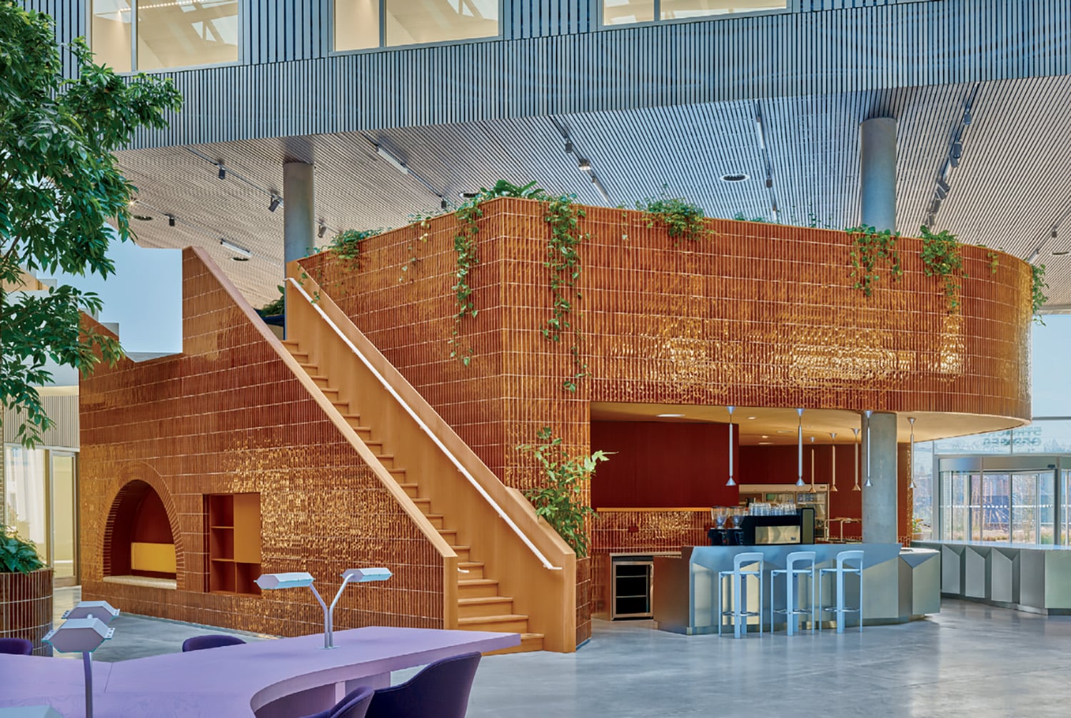 A large room with a staircase and a table.