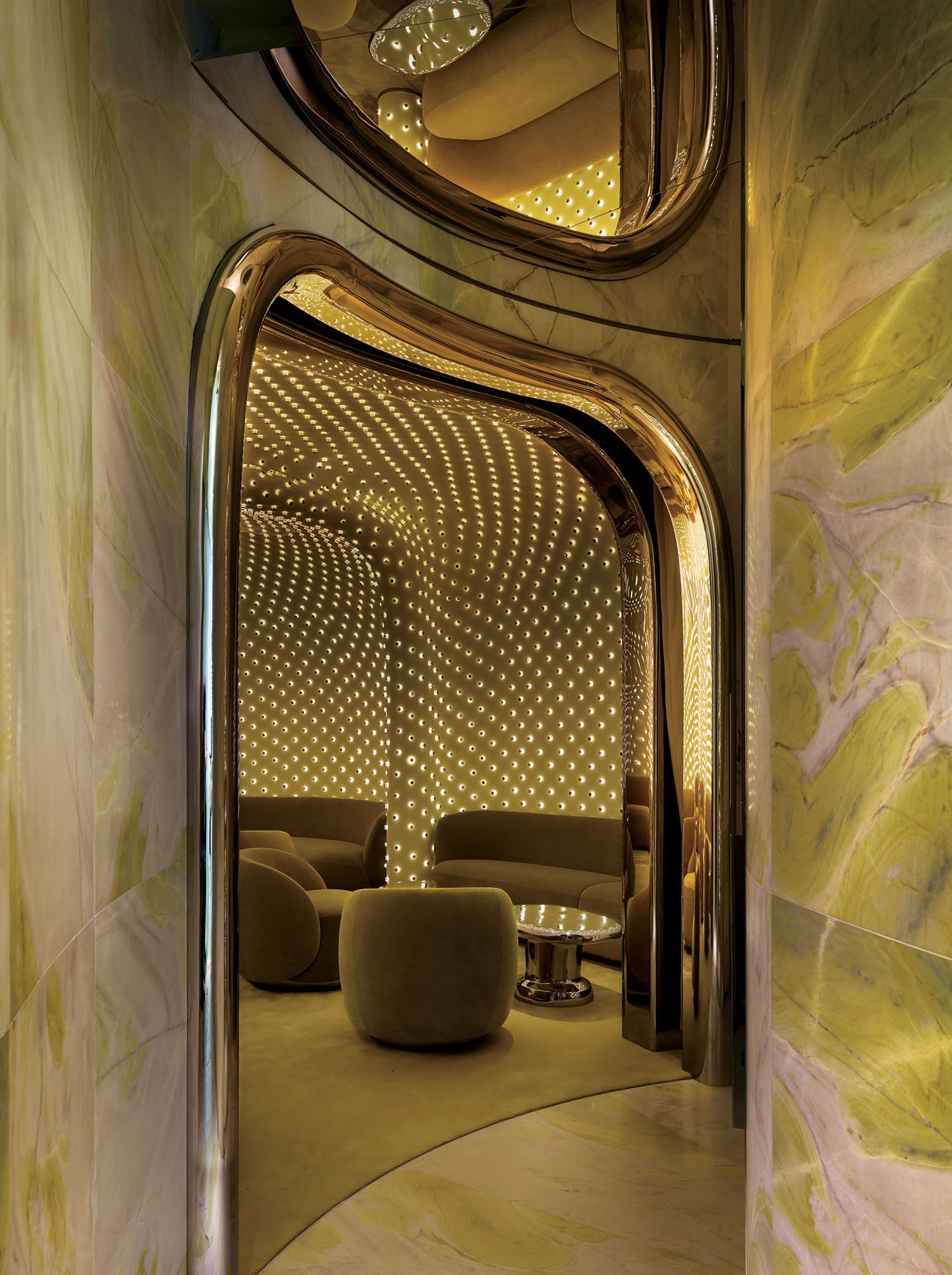 A room with a large mirror and a couch.