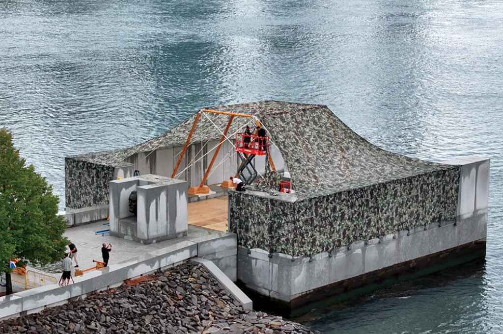 A man is on a platform above the water.