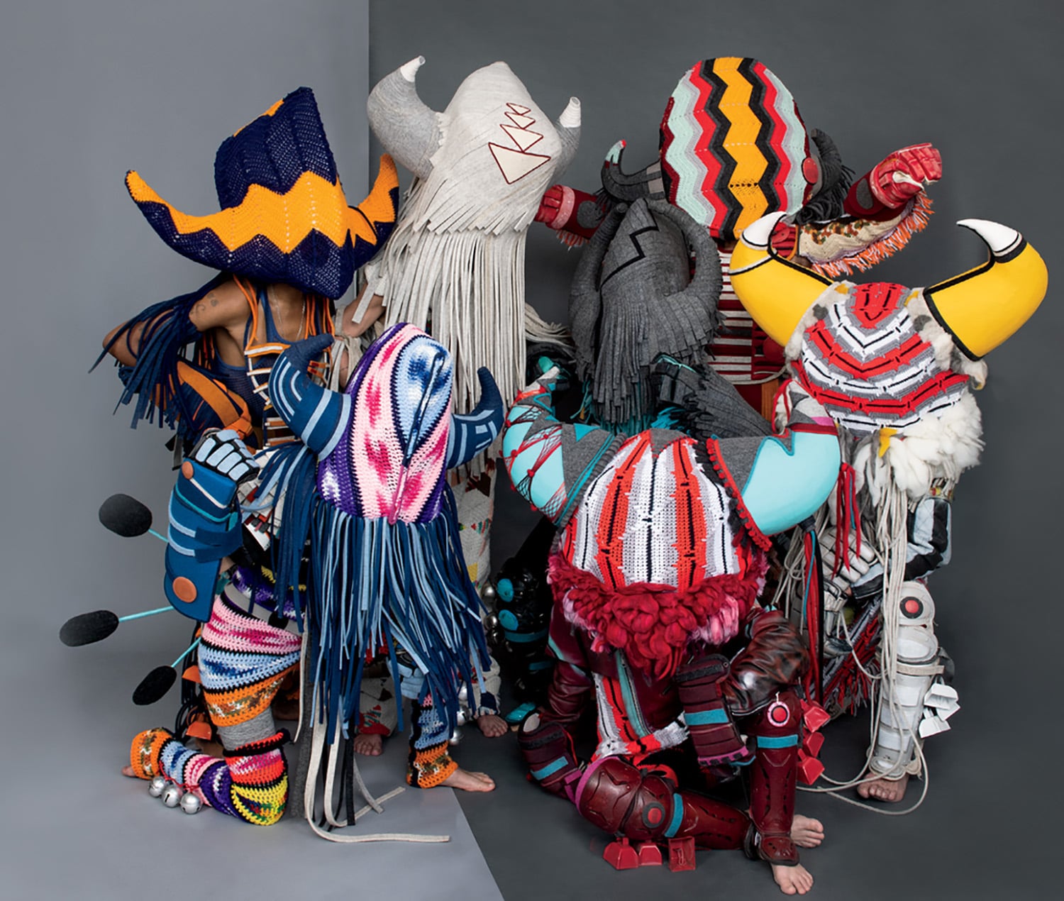 A group of different colored hats and scarles.