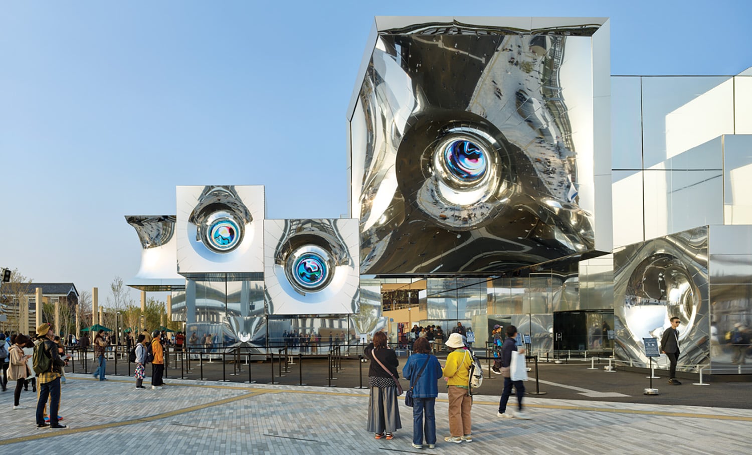 A group of people standing around a building.