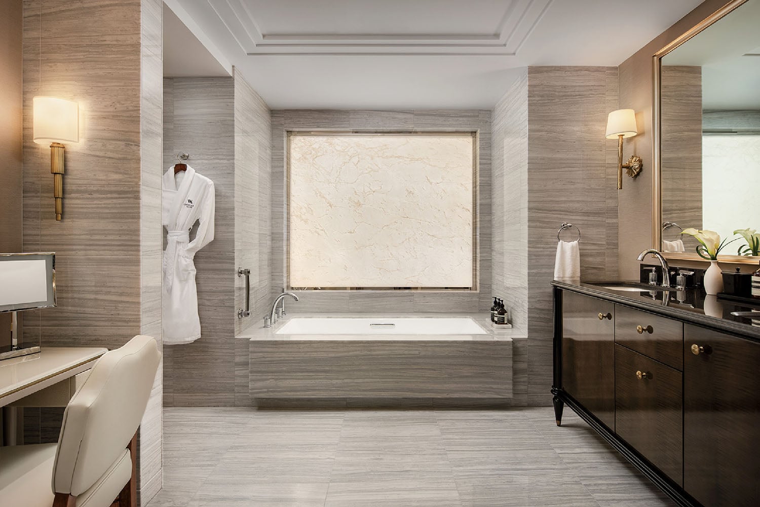 A bathroom with a large tub and a sink.