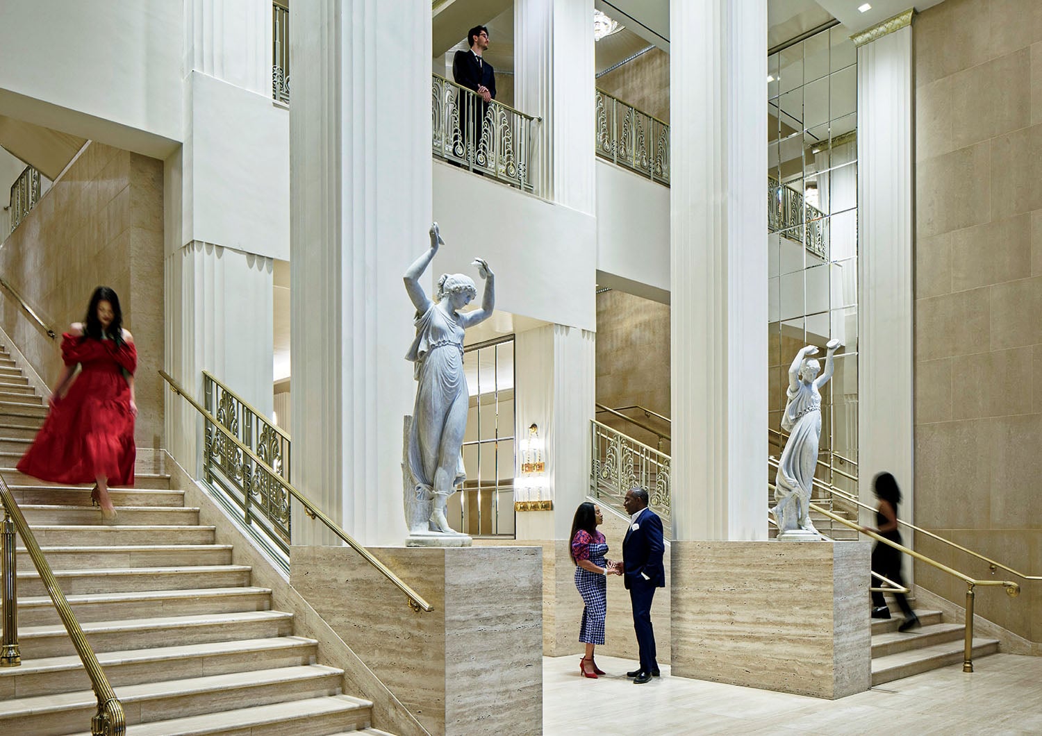 A couple of people walking up some stairs.