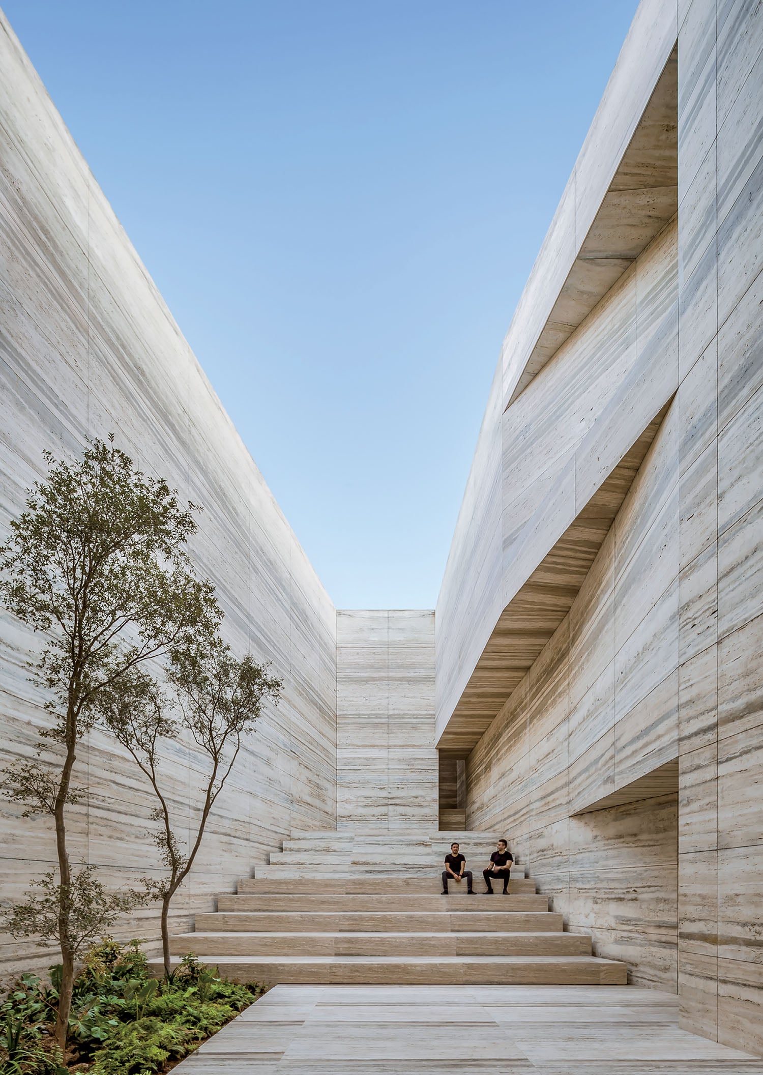 The stairs leading up to the building are made from concrete.