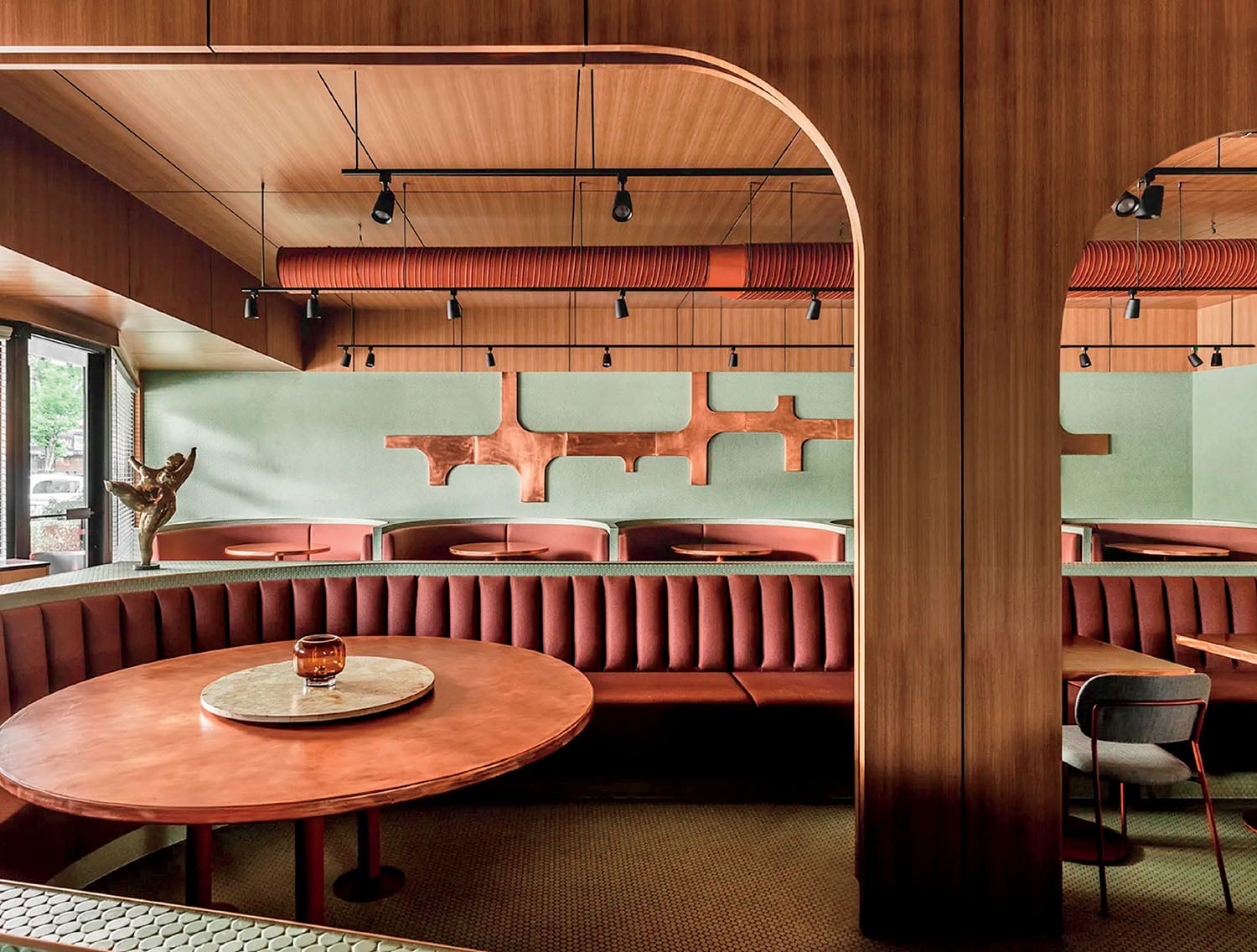 A restaurant with a wooden table and chairs.