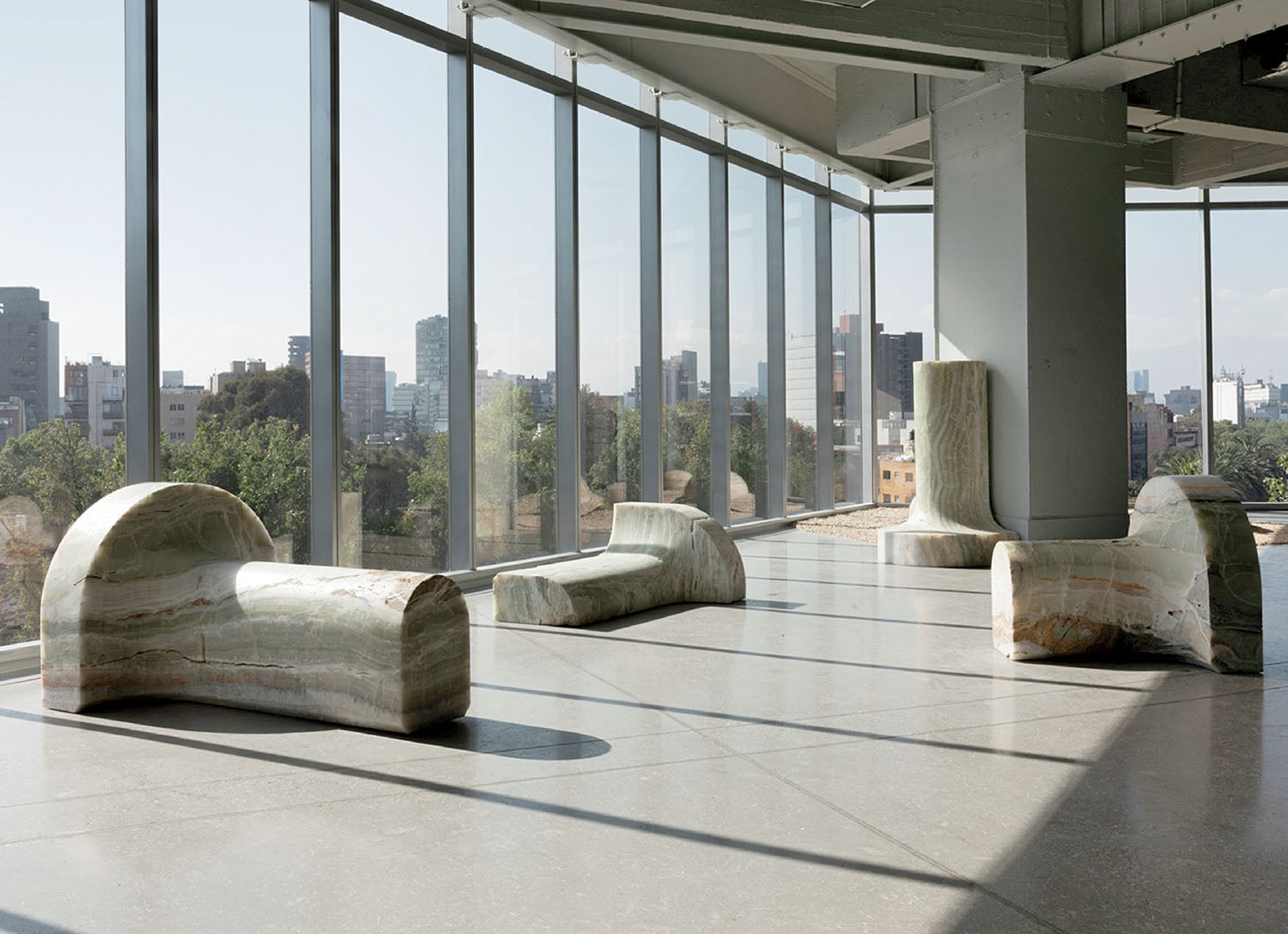 A room with a large window and a large sculpture.