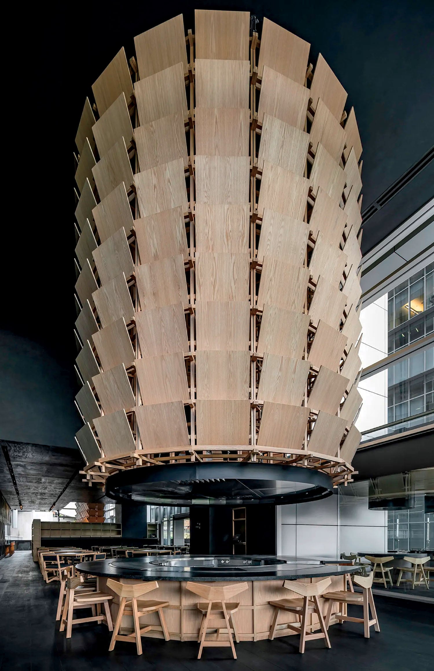 A large wooden structure with a circular table and chairs.