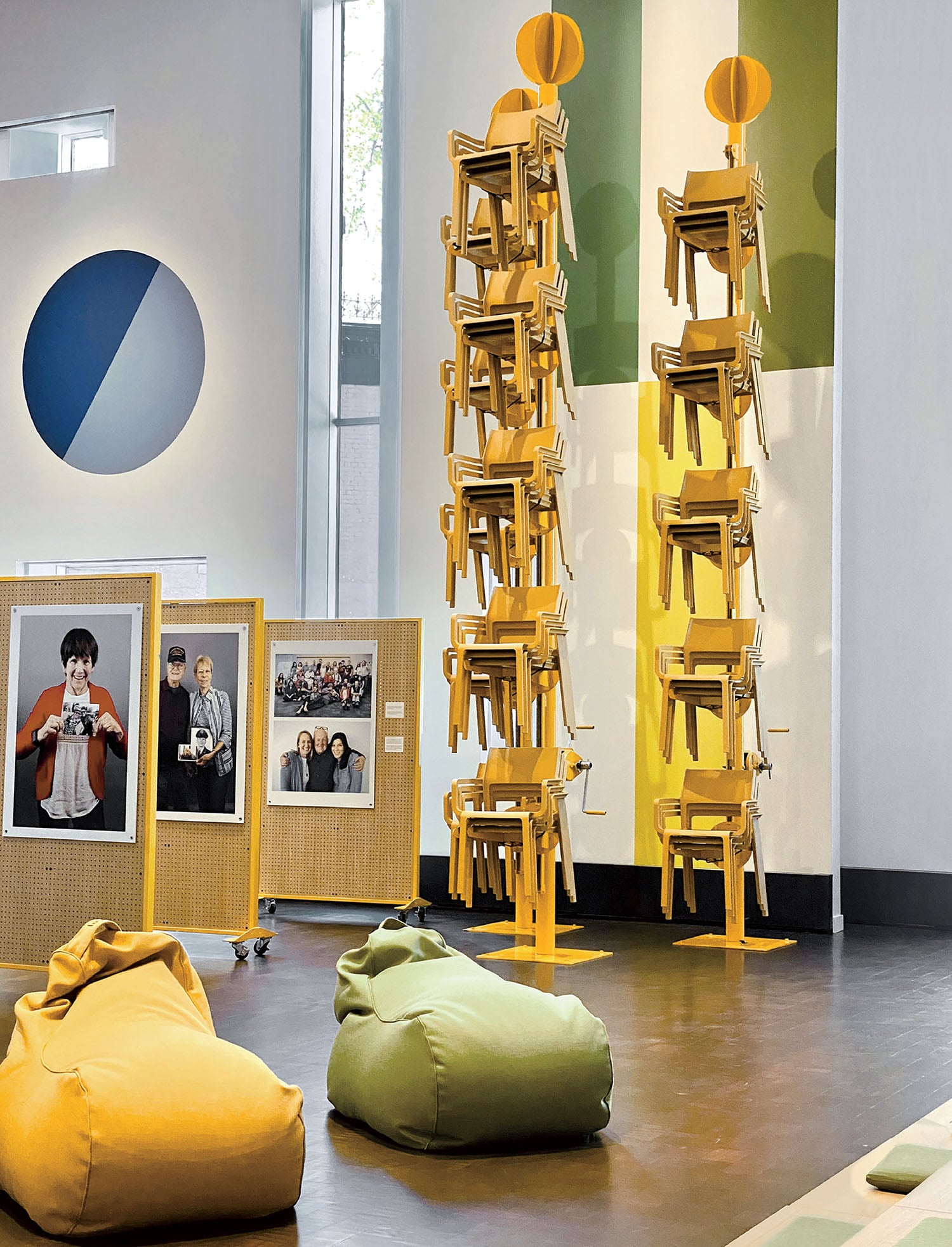 A room with a large number of chairs and a large sculpture.