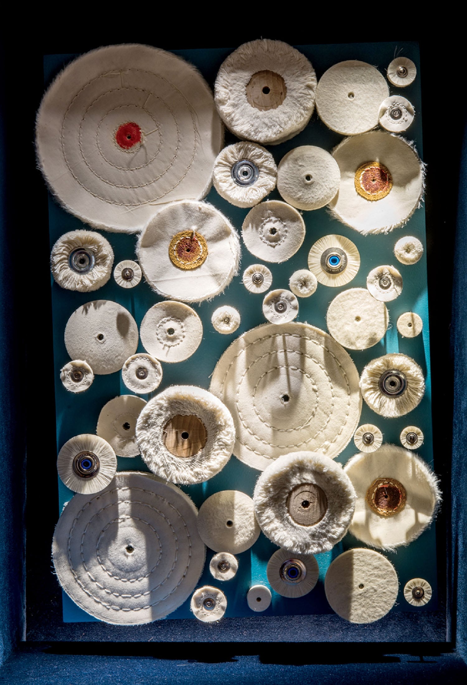 A blue box with a bunch of white plates.