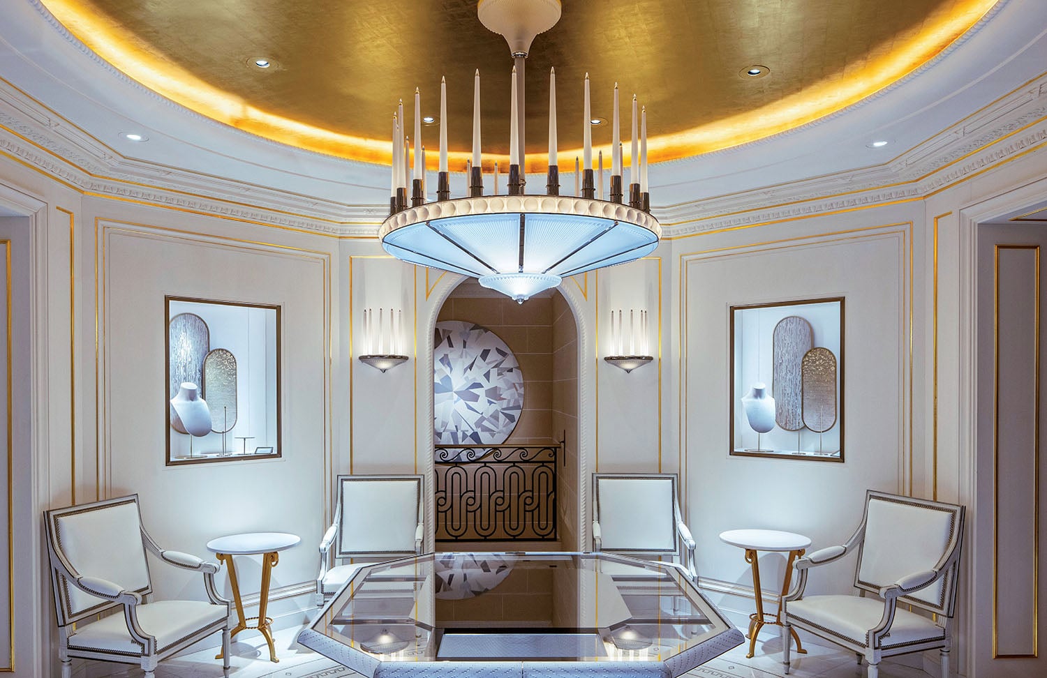 A living room with a chandel and a chandel.