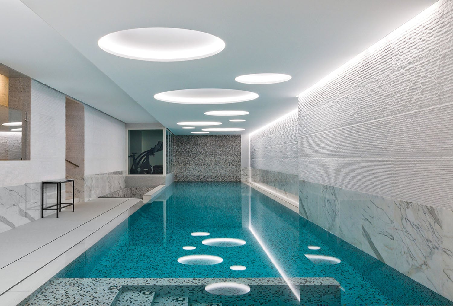 A swimming pool with a large glass floor.