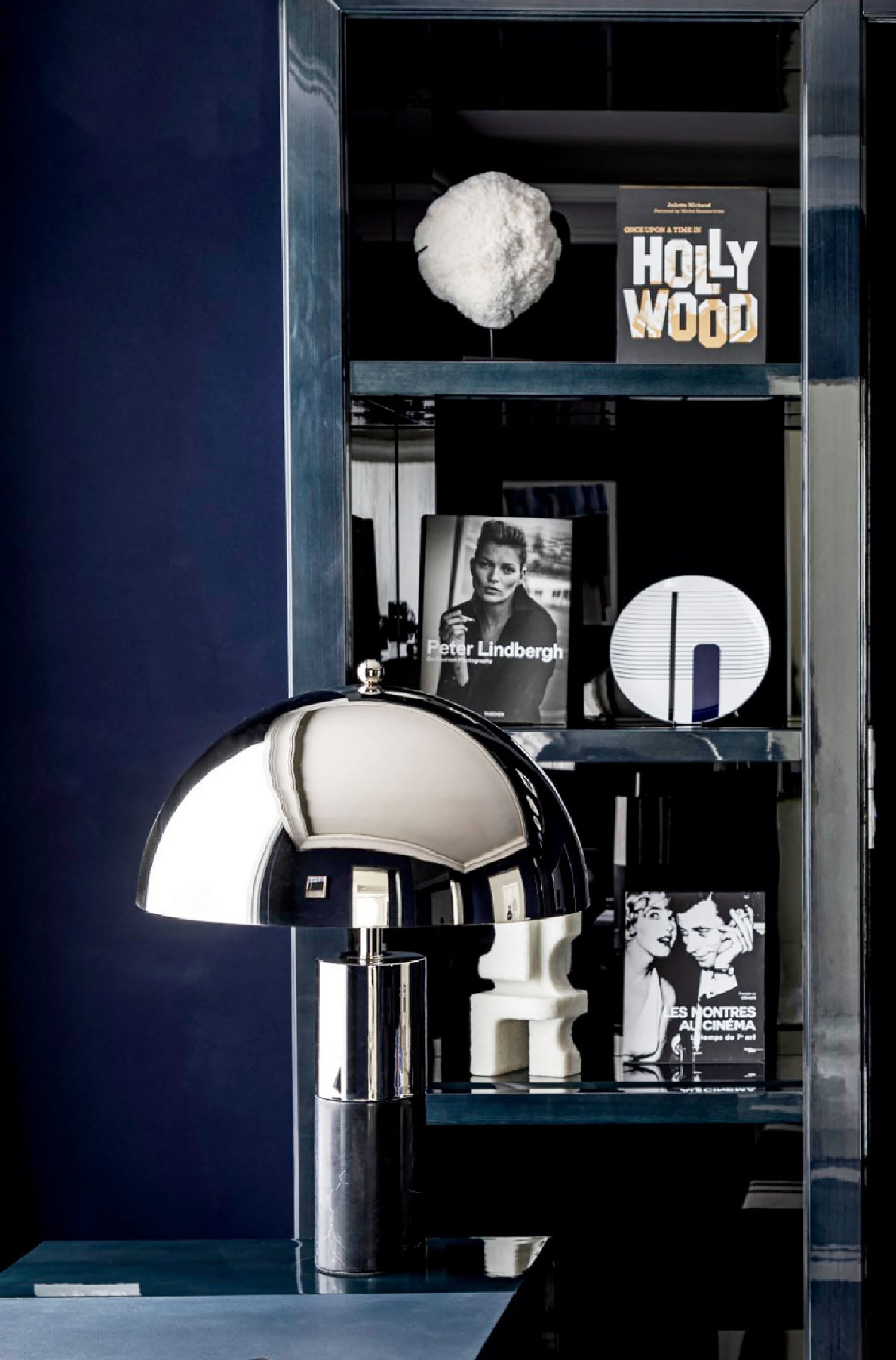 A black and white lamp sitting on top of a blue table.