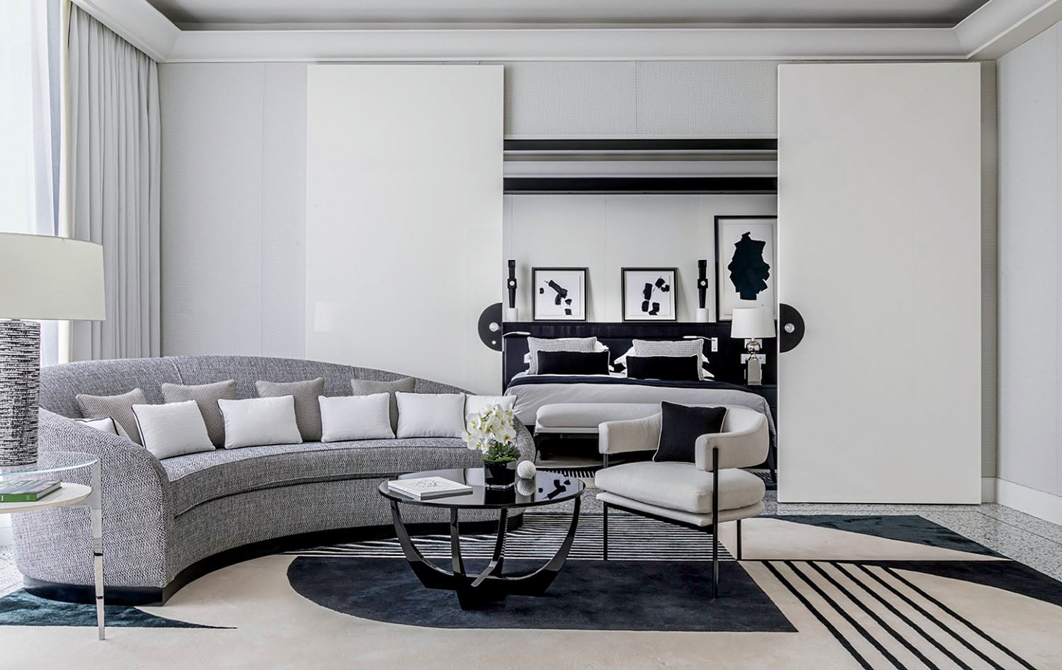 A living room with a round couch and a round table.