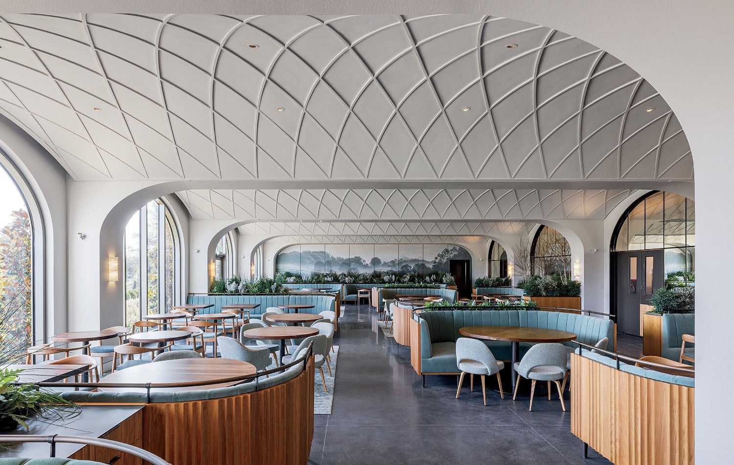 "The interior of the restaurant, with a curved ceiling and wooden"