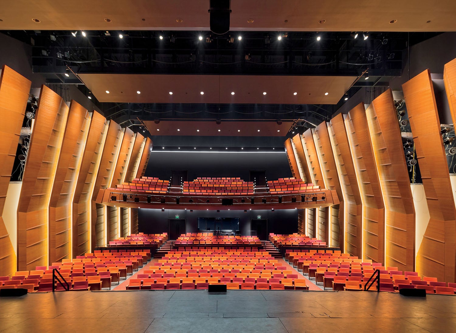 A large auditorium with rows of seats and a stage.