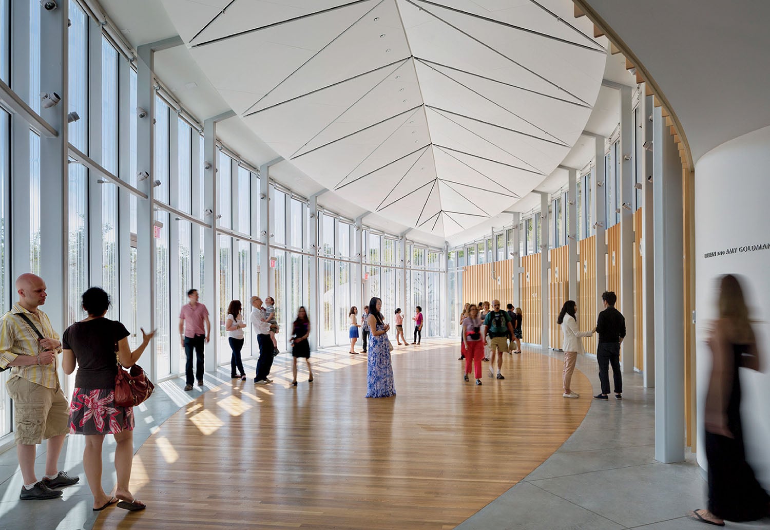A group of people walking through a large building.