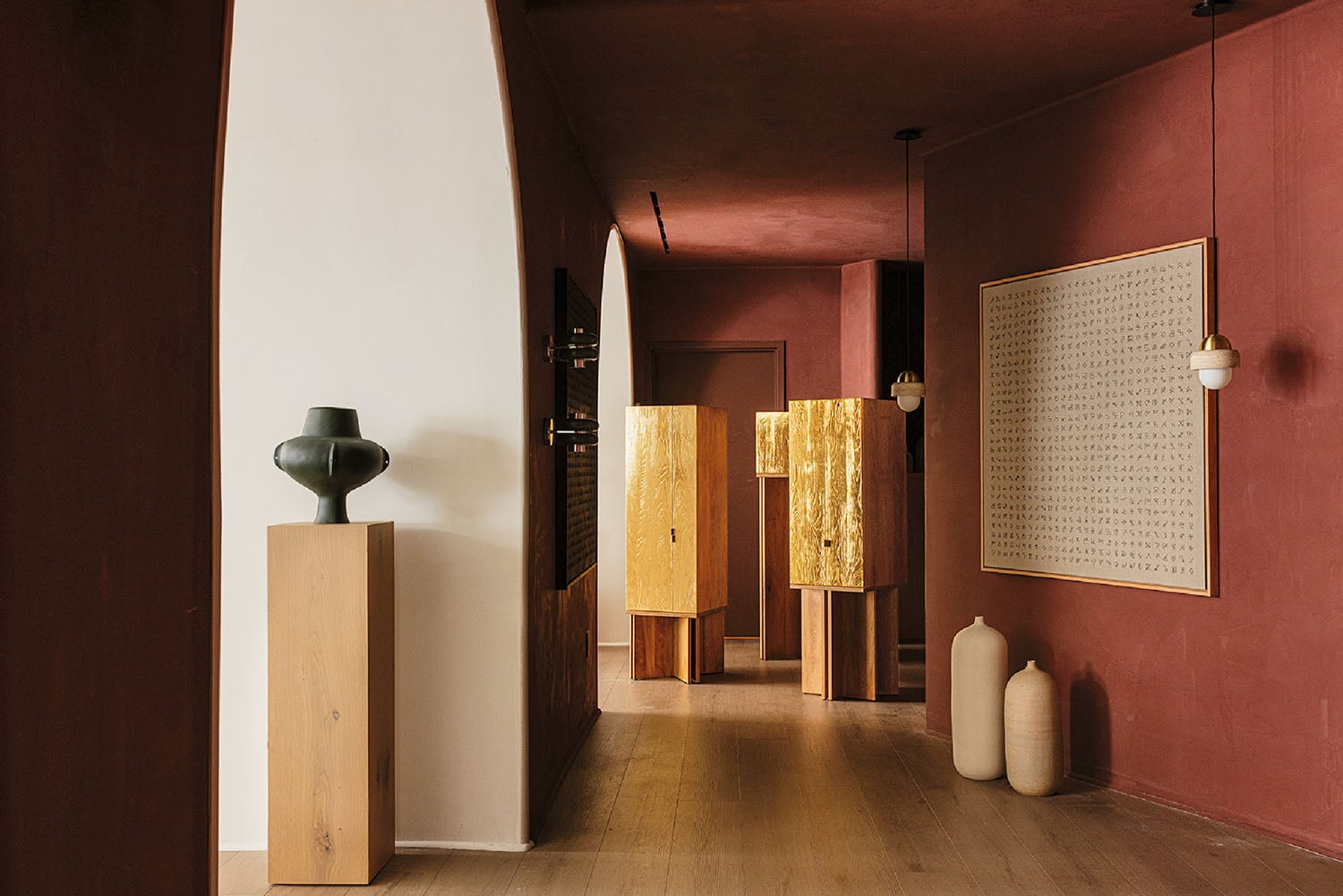 A hallway with a vase and a large painting.