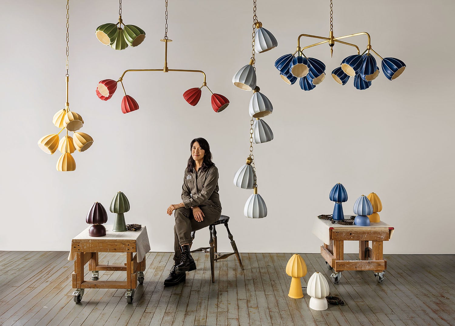 A woman sitting in a chair with many lamps.