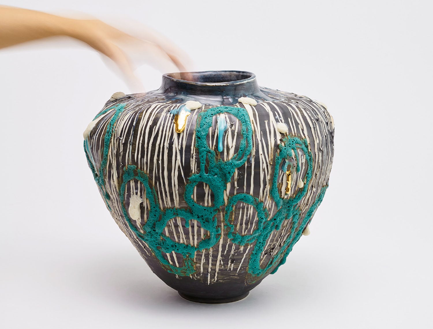 A vase with a snake on it.