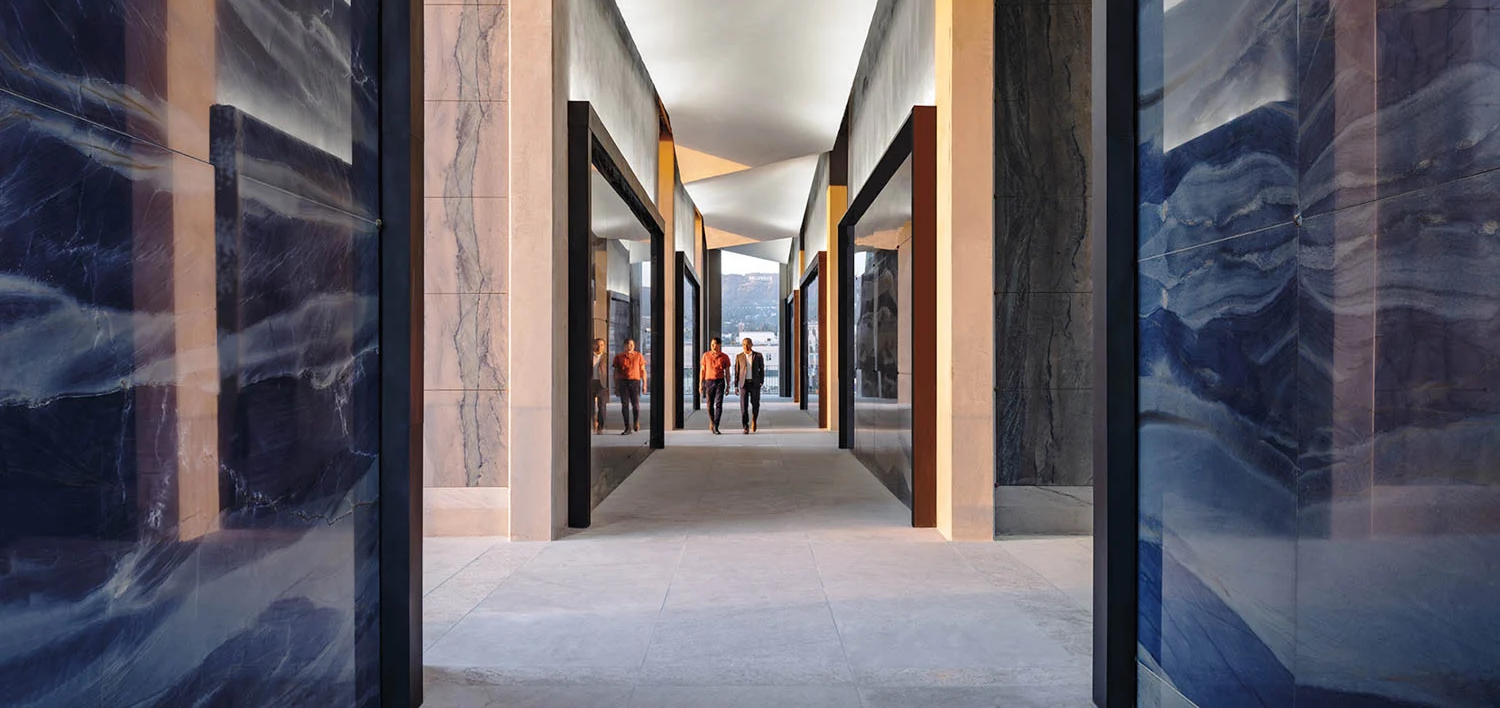 Futuristic corridor with geometric ceiling and glossy blue walls