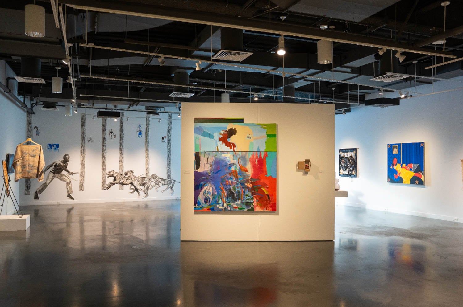 Art gallery with modern paintings and monochrome murals on walls. Centerpiece is vibrant abstract art with bold colors.