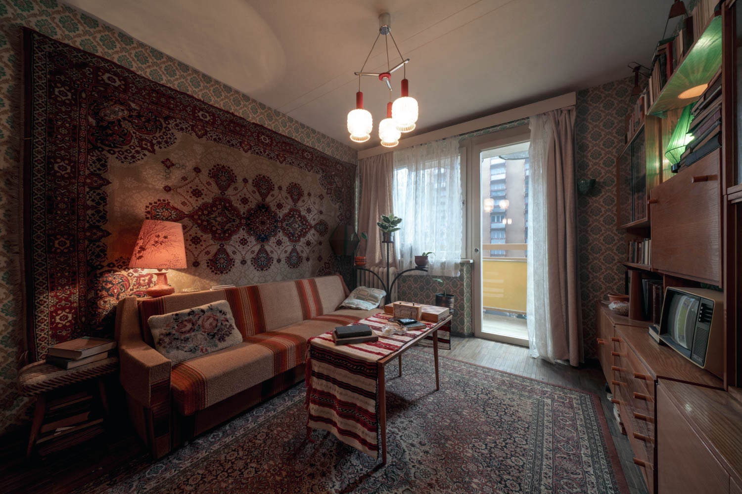 Cozy vintage living room with patterned wallpaper and tapestry