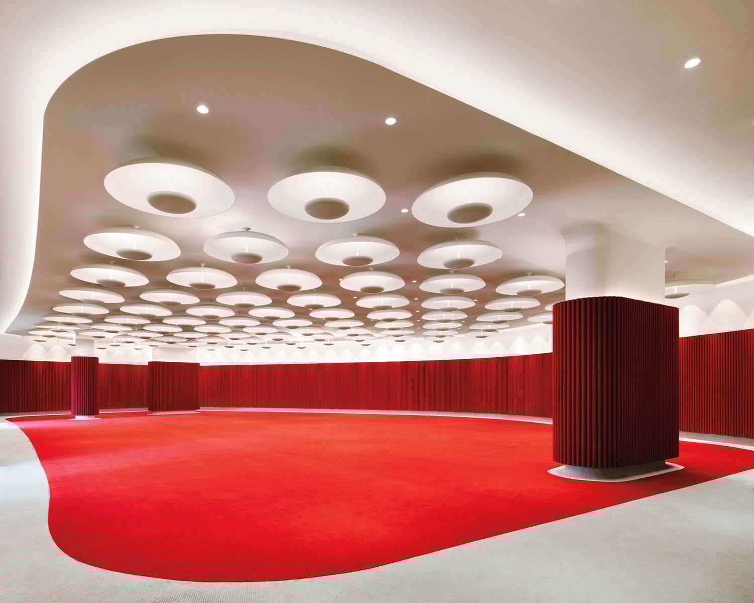 room with red carpet and lights on ceiling