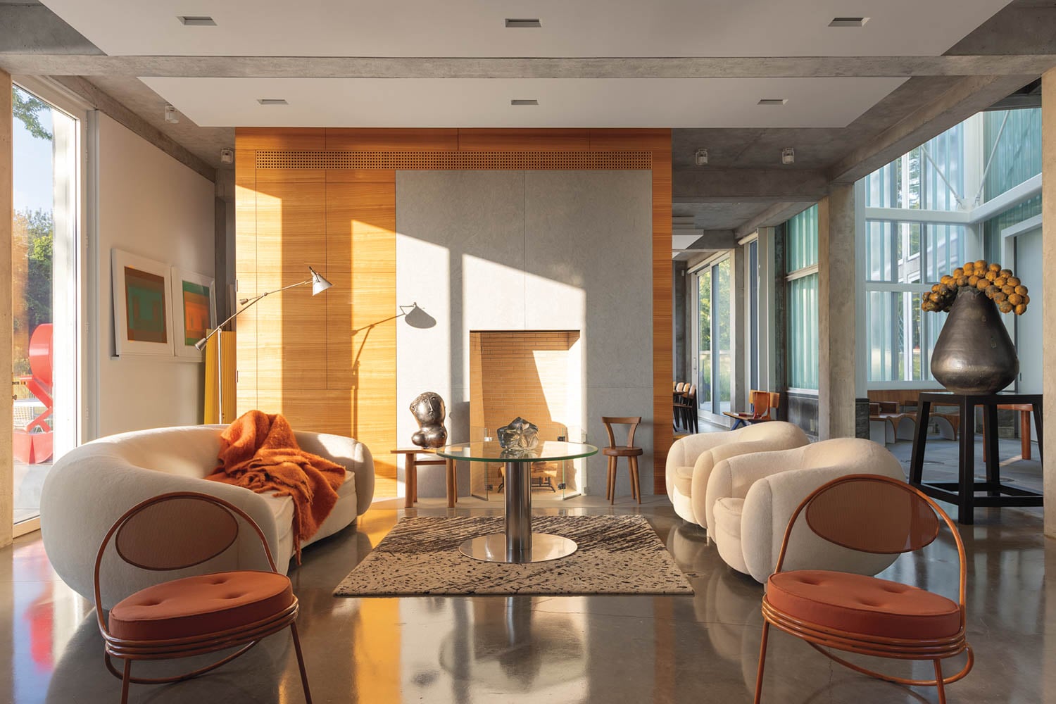 living room area with white couches and orange chairs