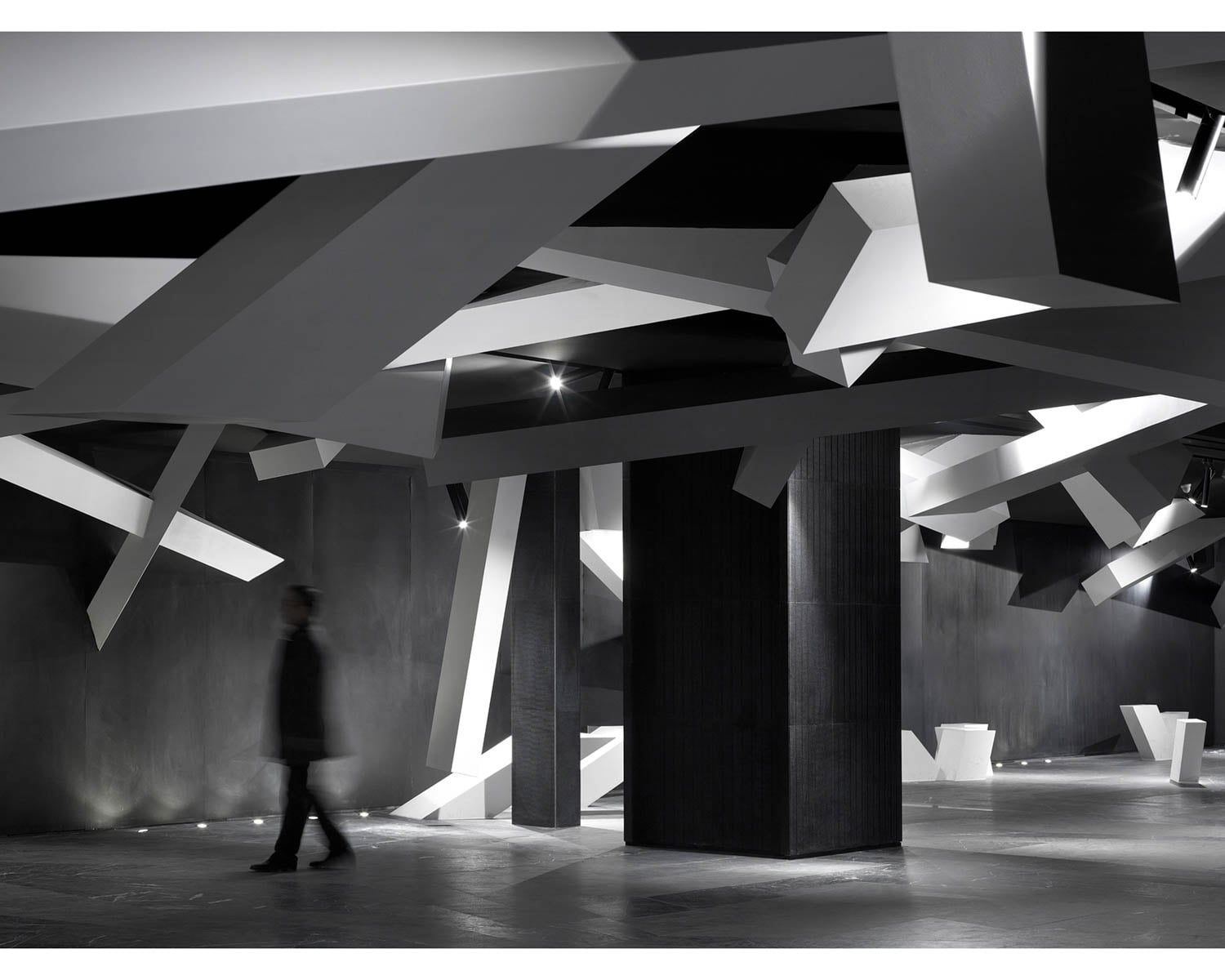 person walking through space with lots of black beams