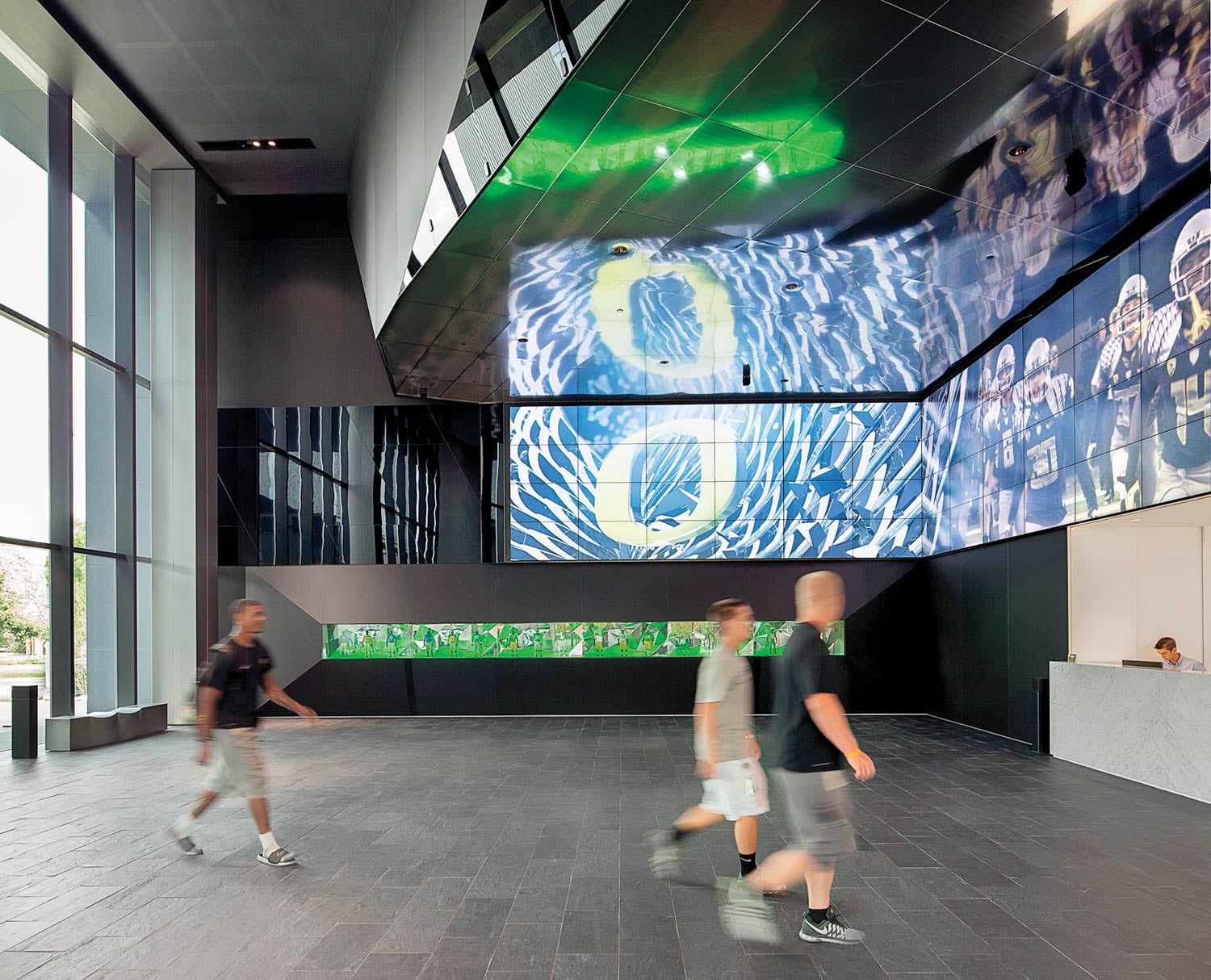 people walking into gym with television