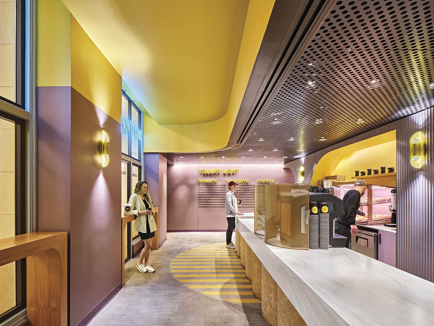 Modern donut shop interior with pastel yellow and purple tones