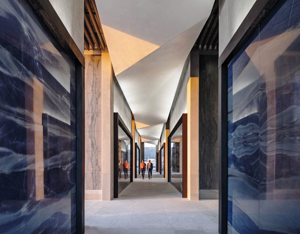 Futuristic corridor with geometric ceiling and glossy blue walls