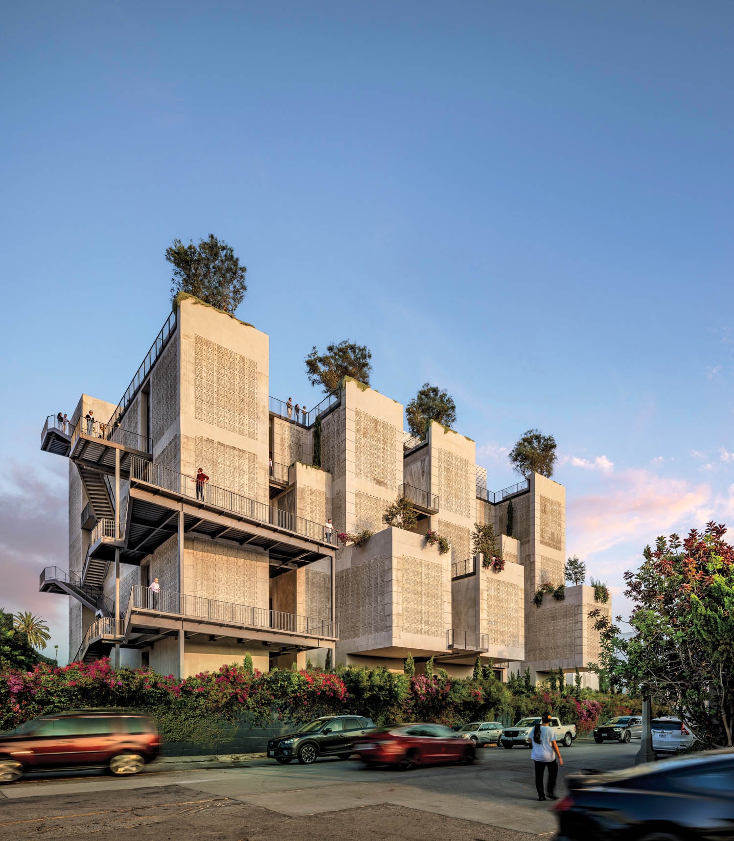 Modern, multi-story building with concrete facades and rooftop gardens