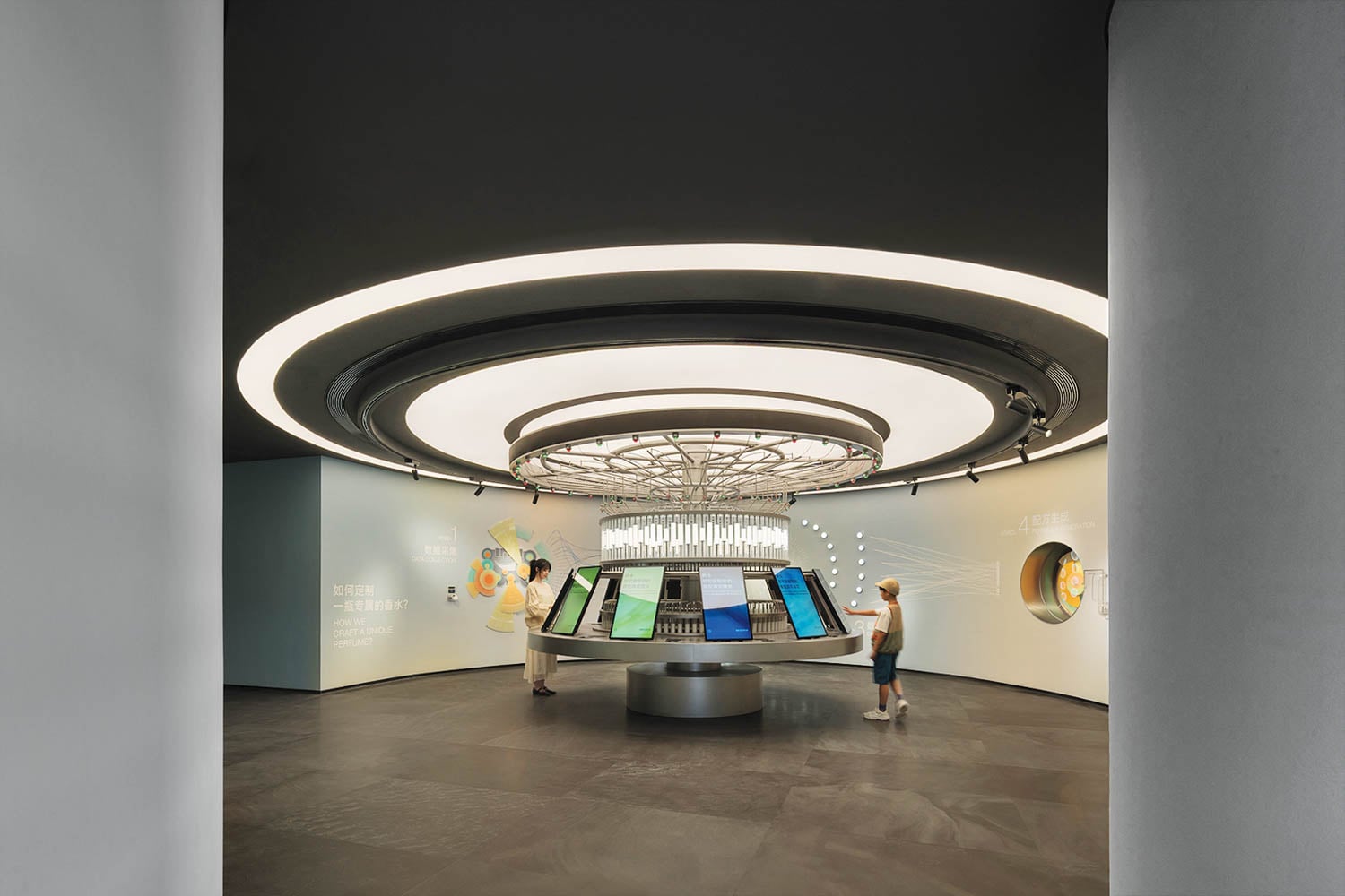 Futuristic exhibition space with a circular interactive display table under modern lighting