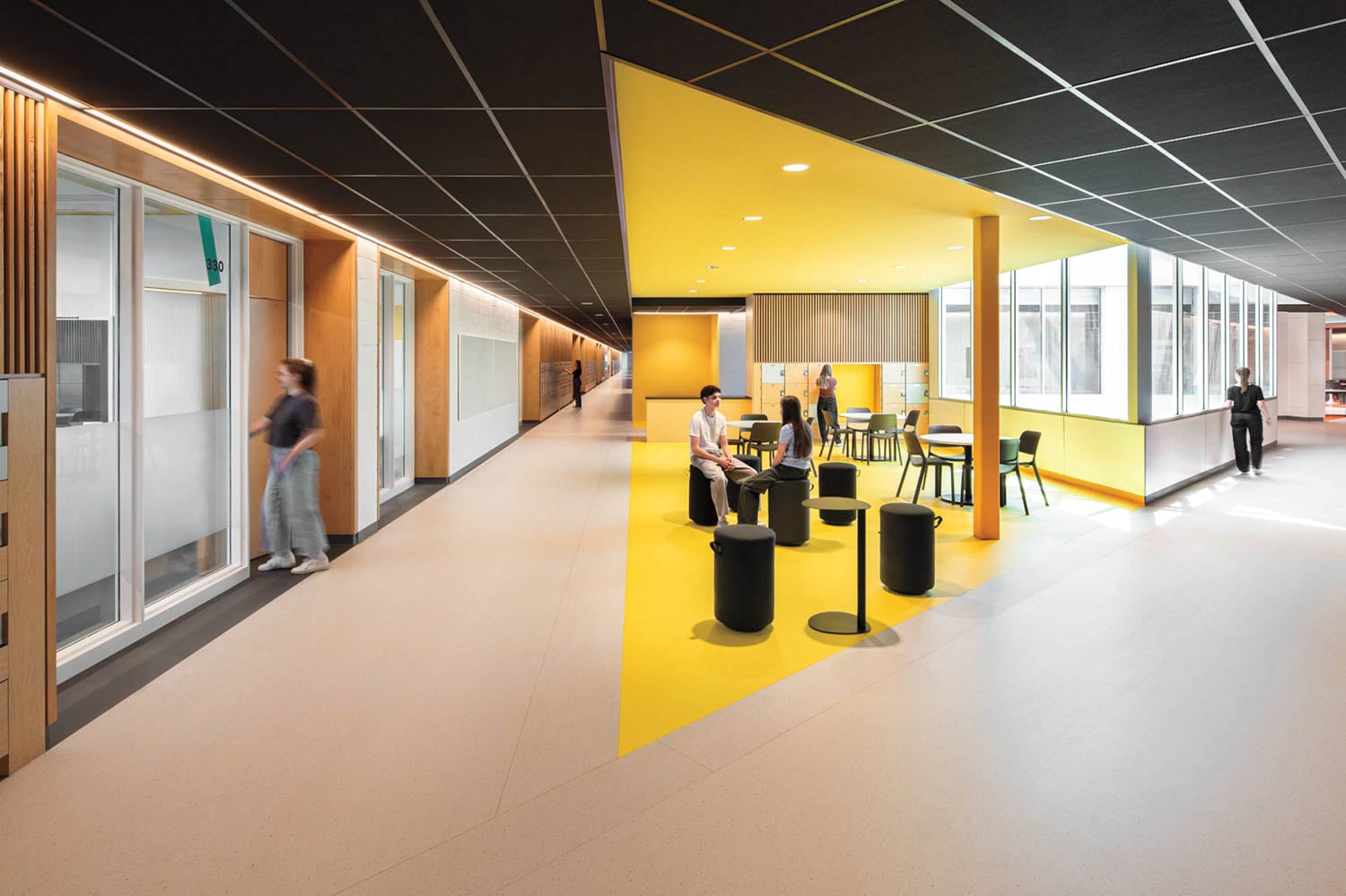 Modern office space with yellow accents and seating area