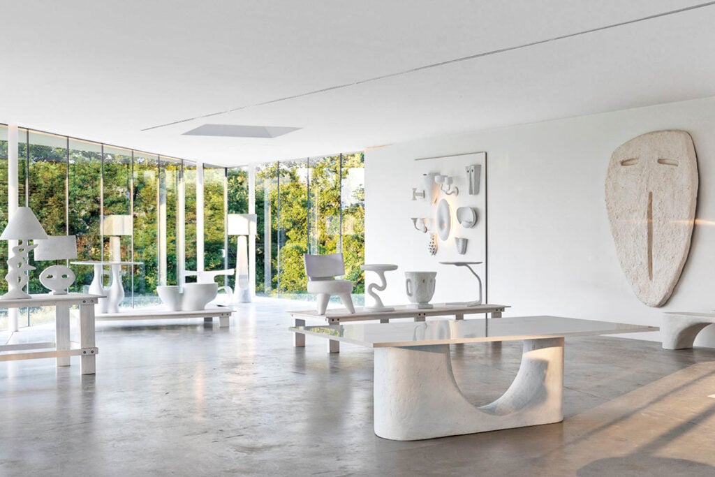 Bright, minimalist room with modern white abstract furniture and art