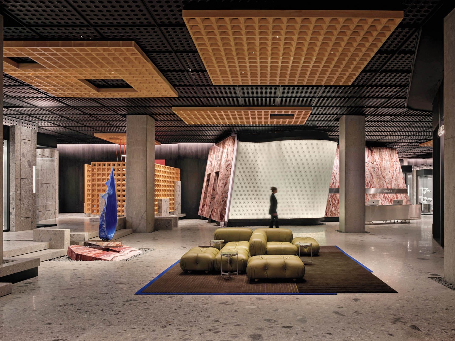 Modern interior with geometric ceiling, abstract art, and olive green seating