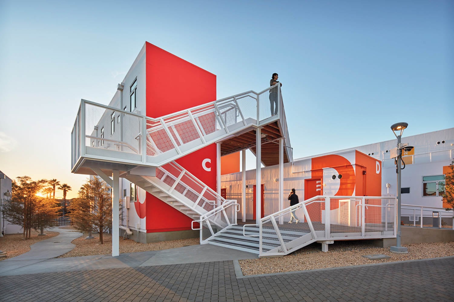 Modern architecture with bold red walls labeled 'C' and 'D'