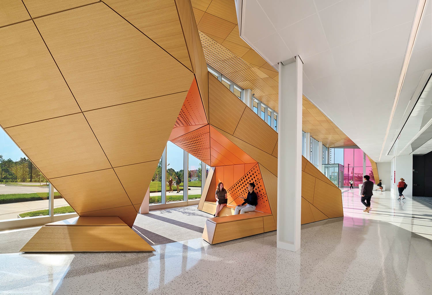 Modern interior with large, angular wooden structures forming seating alcoves