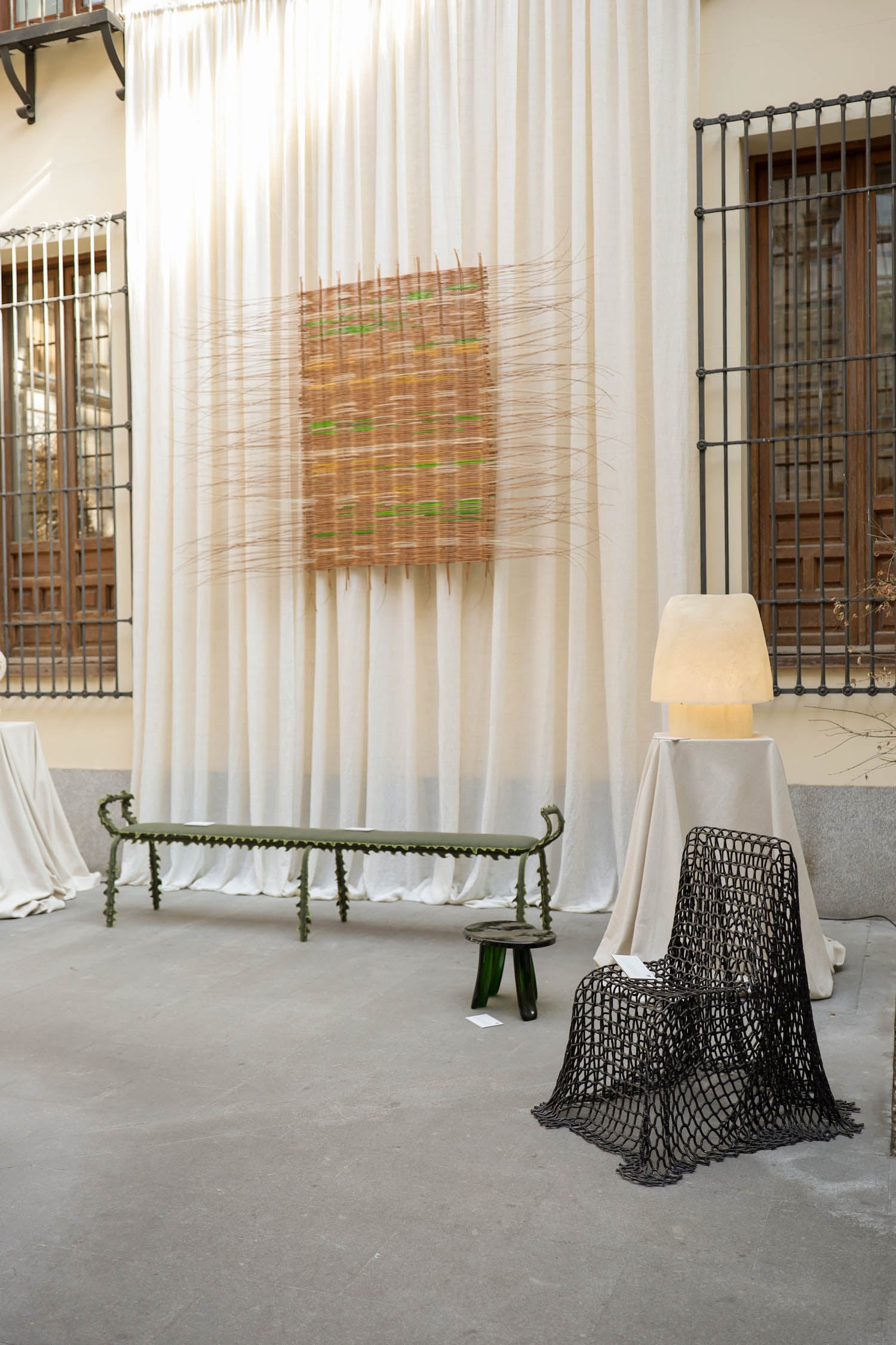 room with white sheets and painting on wall