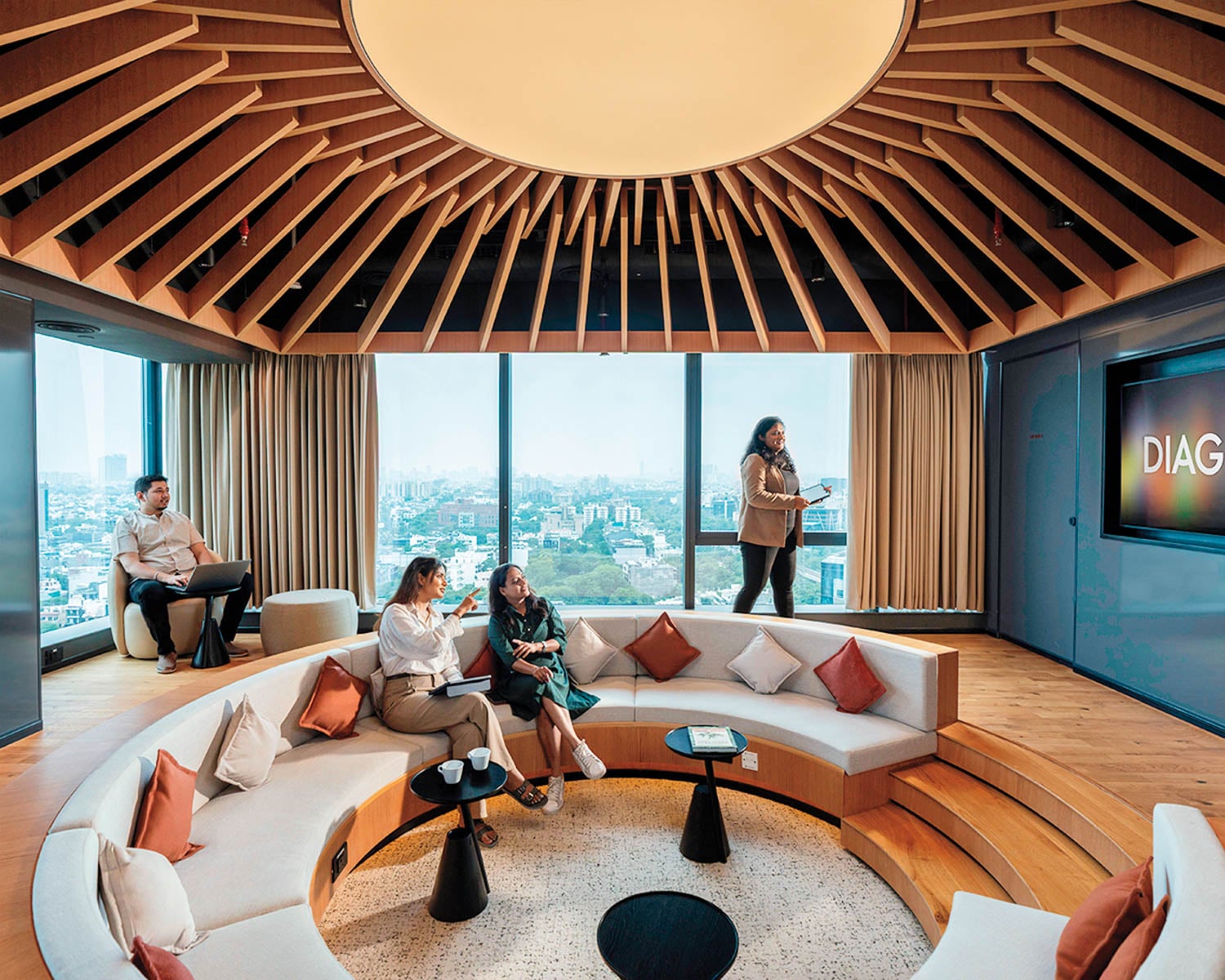 Semi-circular modern meeting room with a large window showing a cityscape