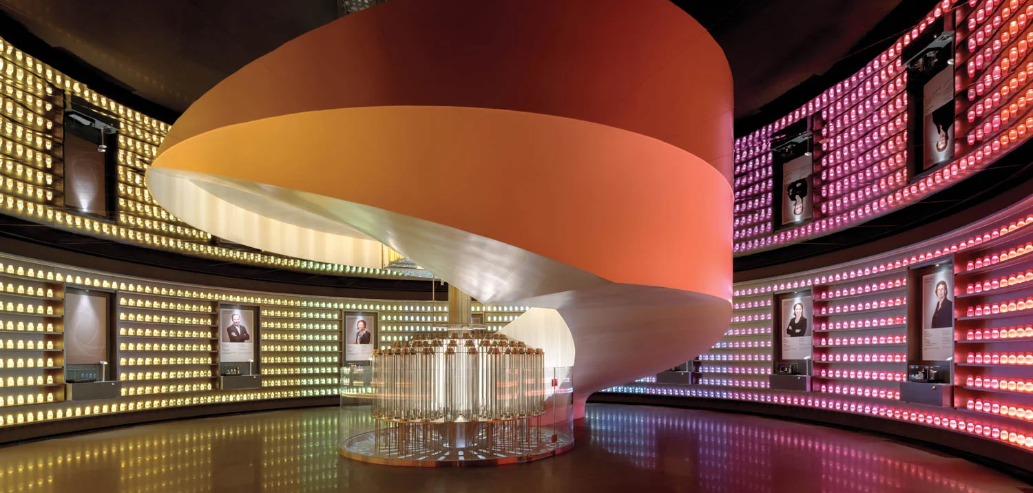 Futuristic room with a central, spiral staircase in warm orange hues