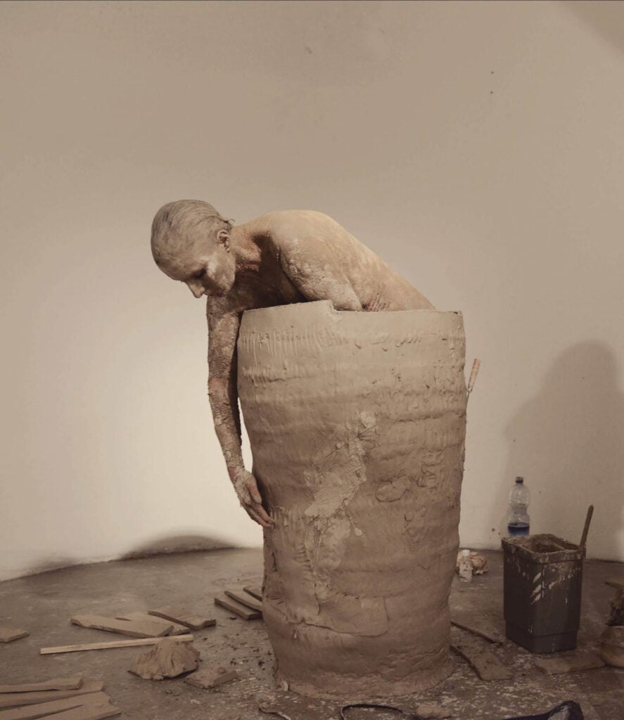 person inside a clay vessel